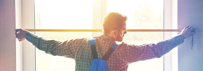 Man measures window frame