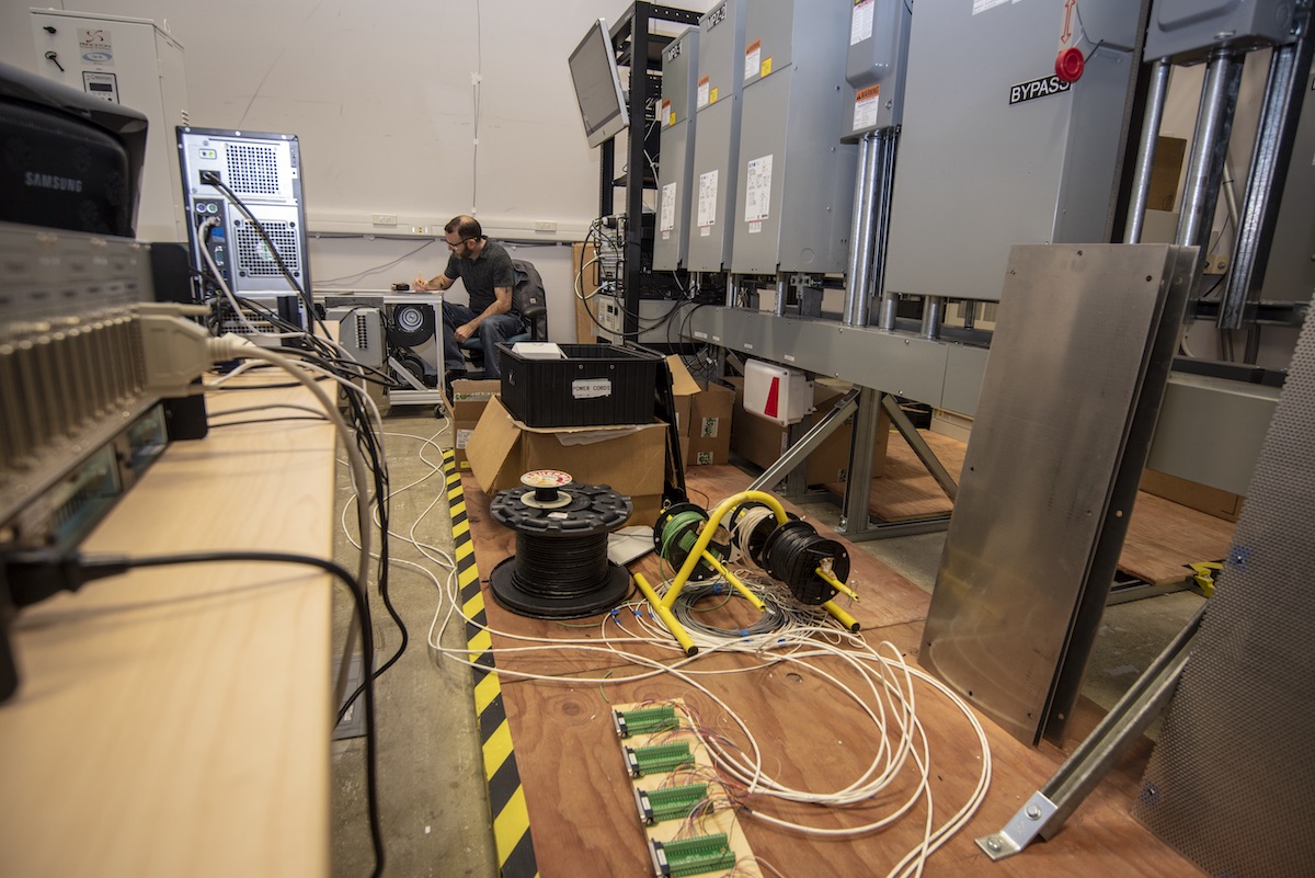 FLEXLAB Engineering Manager Ari Harding works on setup and commissioning of one of seven new programmable load banks used in FLEXLAB's ARPA-E funded hardware-in-the-loop grid integration project lead by Northwestern University.