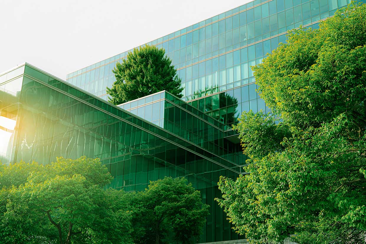 Glass office building exterior with trees in front