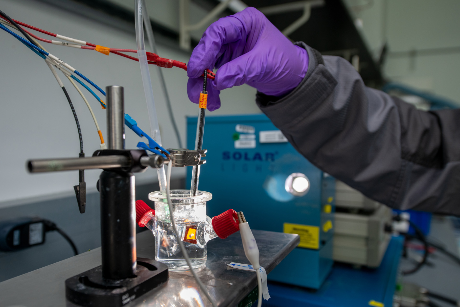 A LiSA scientist adjusts a solar fuel cell prototype.