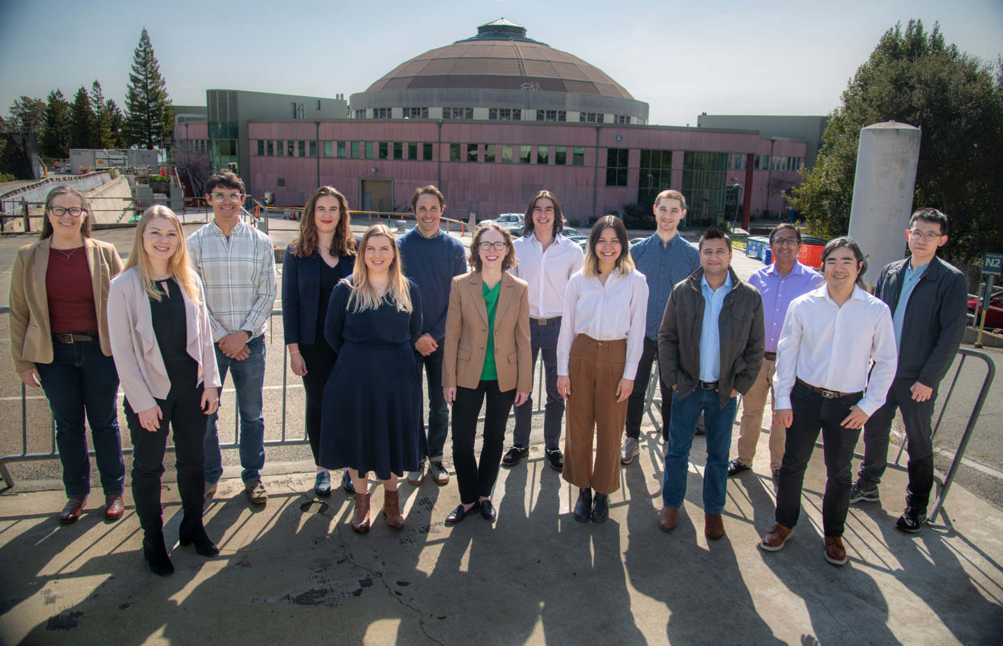 Group of scientists stands together outside at Berkeley Lab.  Berkeley Lab’s Technoeconomic Analysis Team provides analytical insight into ways to balance economic realities with sustainability goals. (Credit: Thor Swift/Berkeley Lab) 